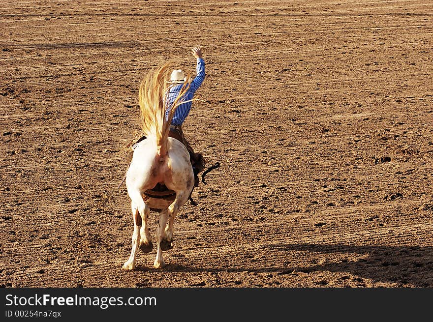 Saddle bronc riding rodeo competition.