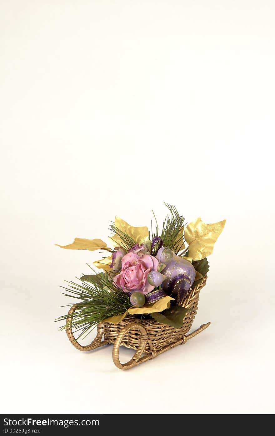 Artificial flowers in a sleigh on white background with space for copy. Artificial flowers in a sleigh on white background with space for copy.