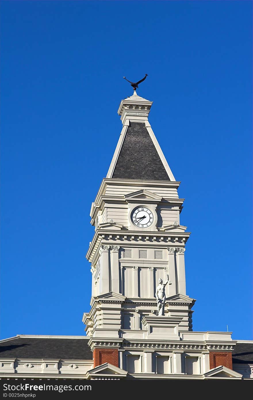 Closeup of Court house with statute of lady justice holding scales. Closeup of Court house with statute of lady justice holding scales