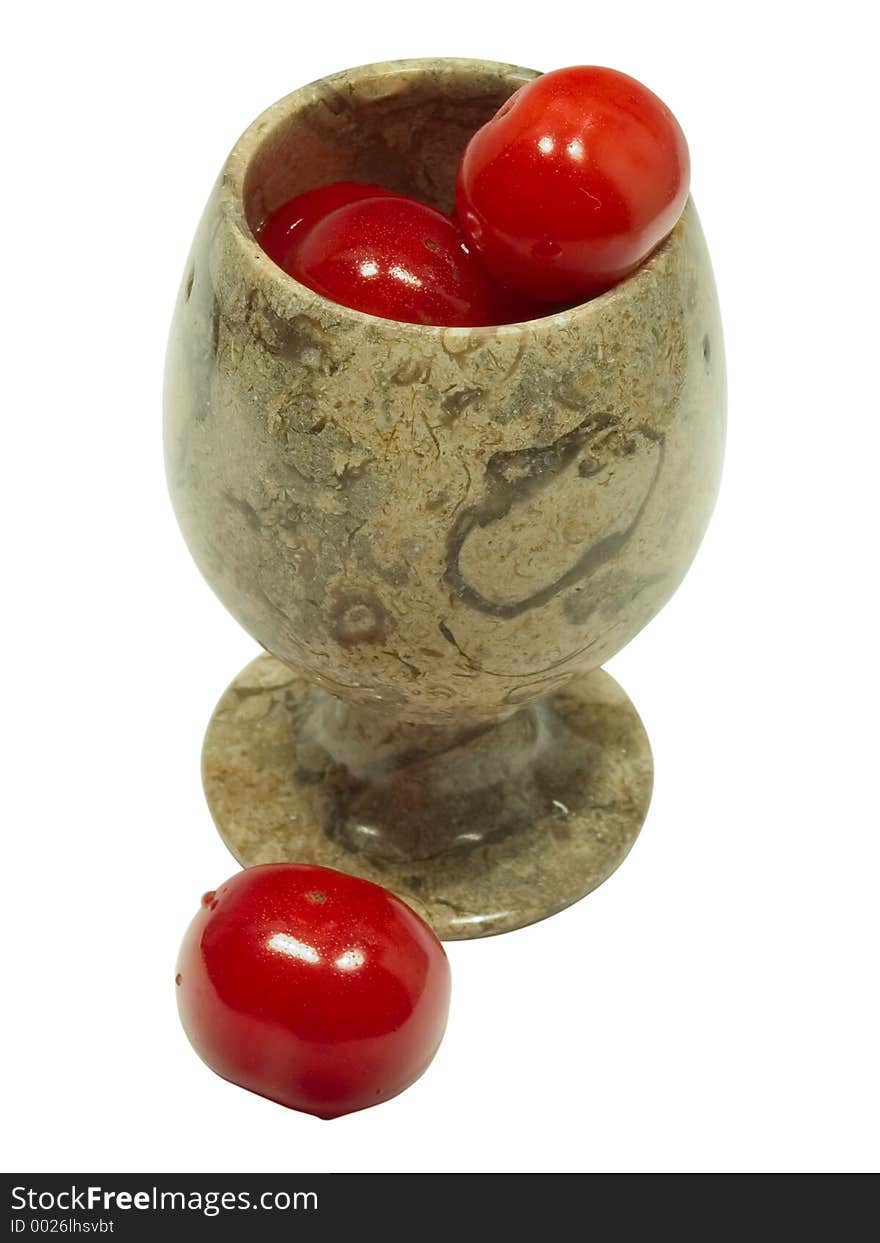 Some cherries in the jasper goblet and one is near. Some cherries in the jasper goblet and one is near