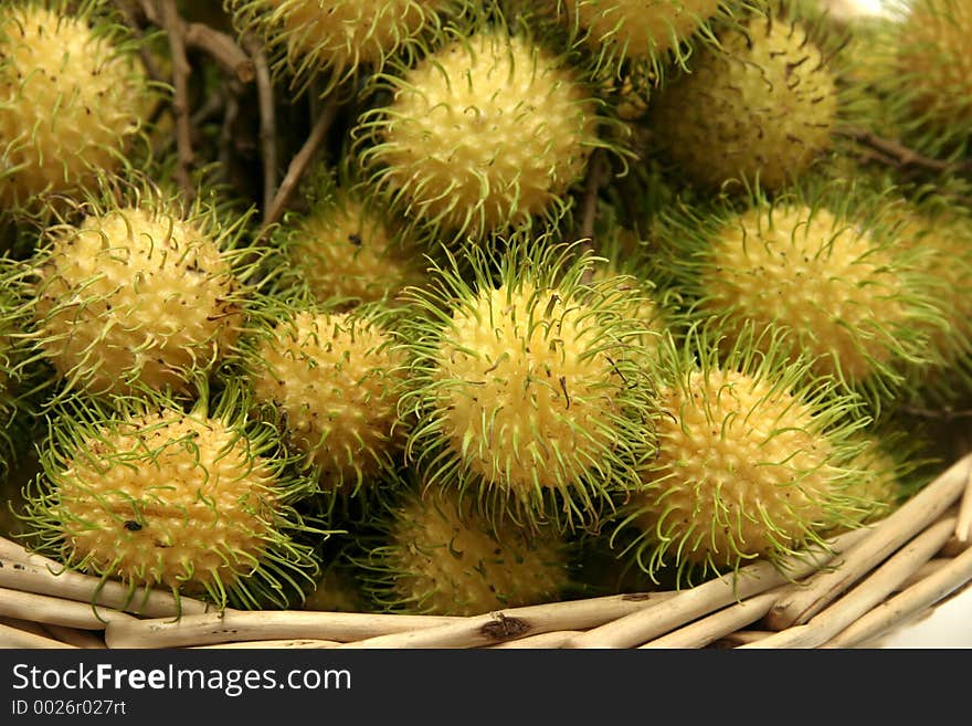 A basket of rambutans, a south east asian sweet, hairy fruit which come in yellow, pink and red varieties