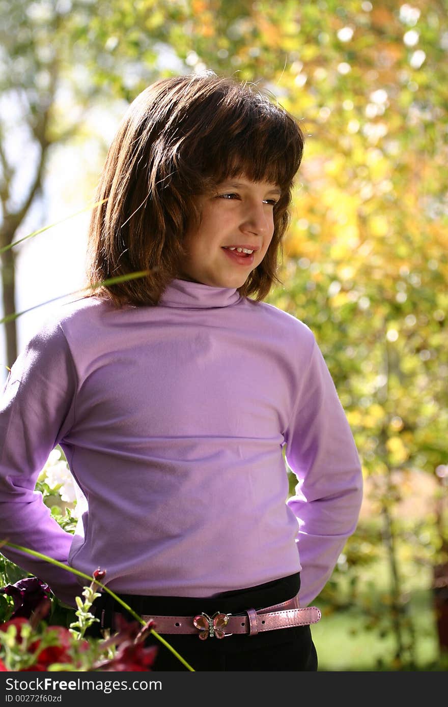 An adorable young Hispanic American girl in the 5-8 year old range. She is wearing a pink purple turtleneck shirt, butterfly belt and has a wonderful smile. An adorable young Hispanic American girl in the 5-8 year old range. She is wearing a pink purple turtleneck shirt, butterfly belt and has a wonderful smile.