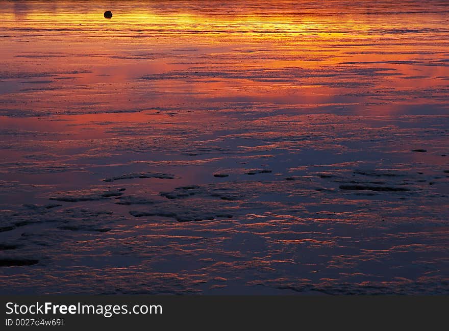 Sunset reflected in the sea in Borgarnes, Borgarfjordur, Iceland. Sunset reflected in the sea in Borgarnes, Borgarfjordur, Iceland