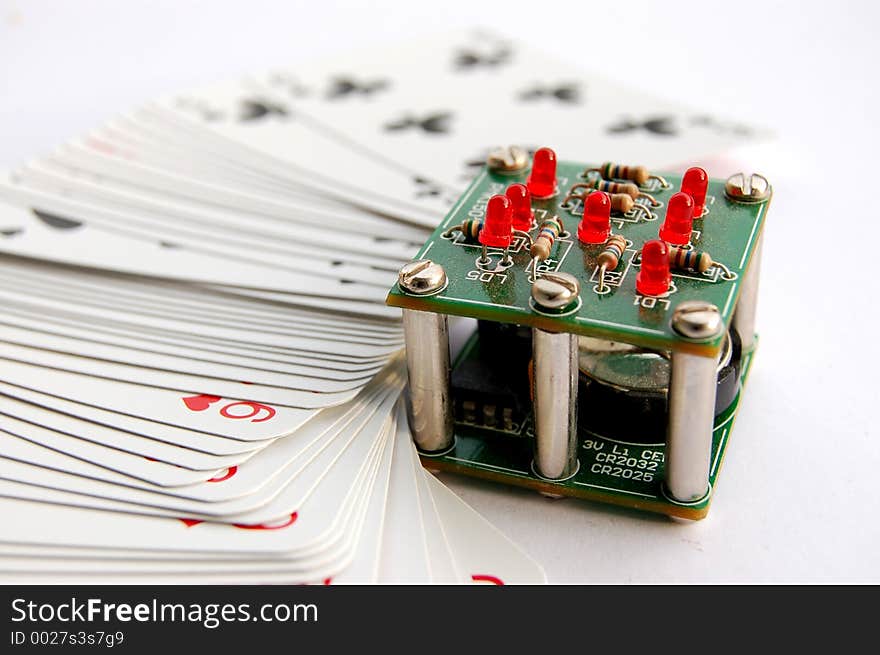 This is an image of an electronic dice with a stack of cards. Metaphor for fixed game etc. This is an image of an electronic dice with a stack of cards. Metaphor for fixed game etc..