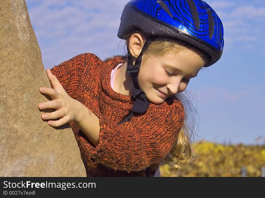 Girl climbing up and looking down