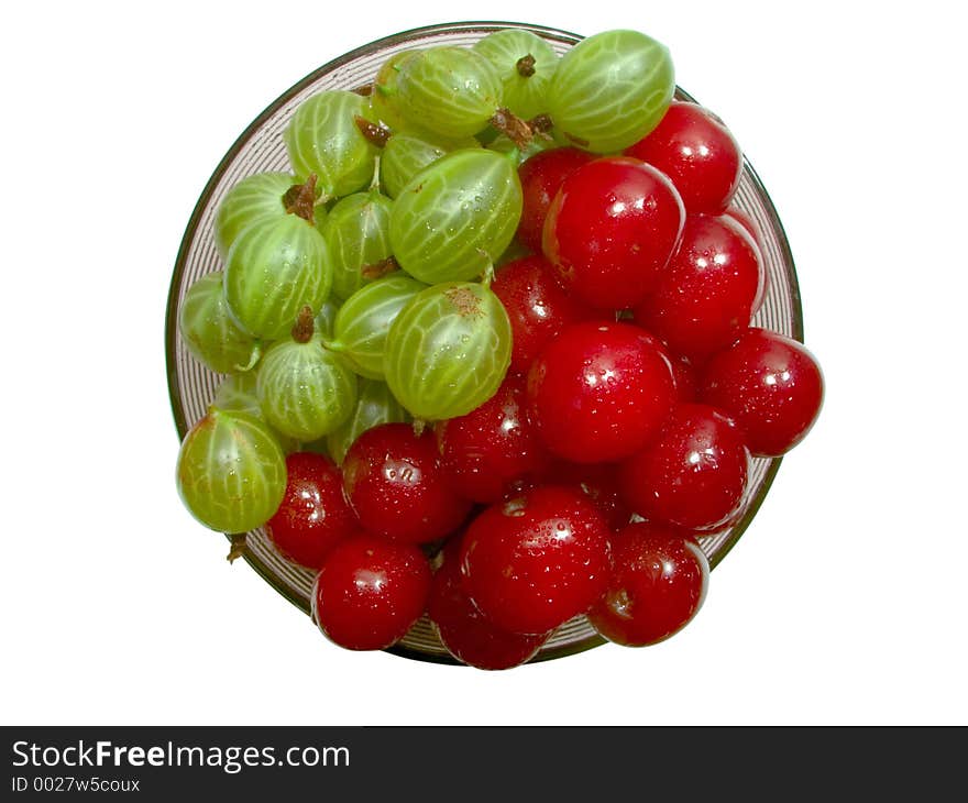 Top view of cherries and gooseberries in the glass jam dish. Top view of cherries and gooseberries in the glass jam dish