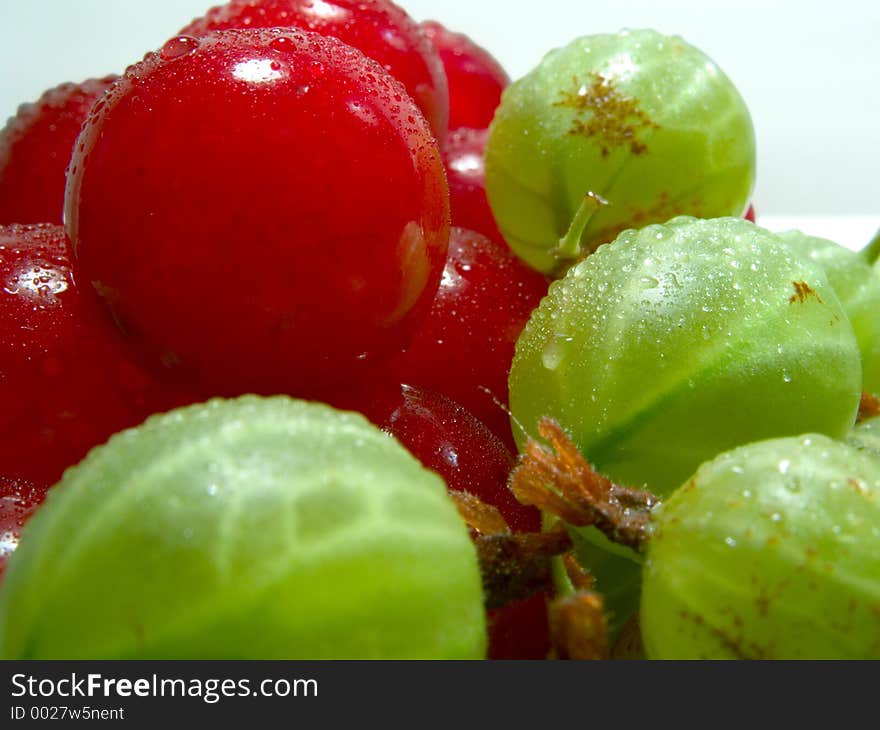 Fresh cherries and gooseberries with drops on them. Fresh cherries and gooseberries with drops on them