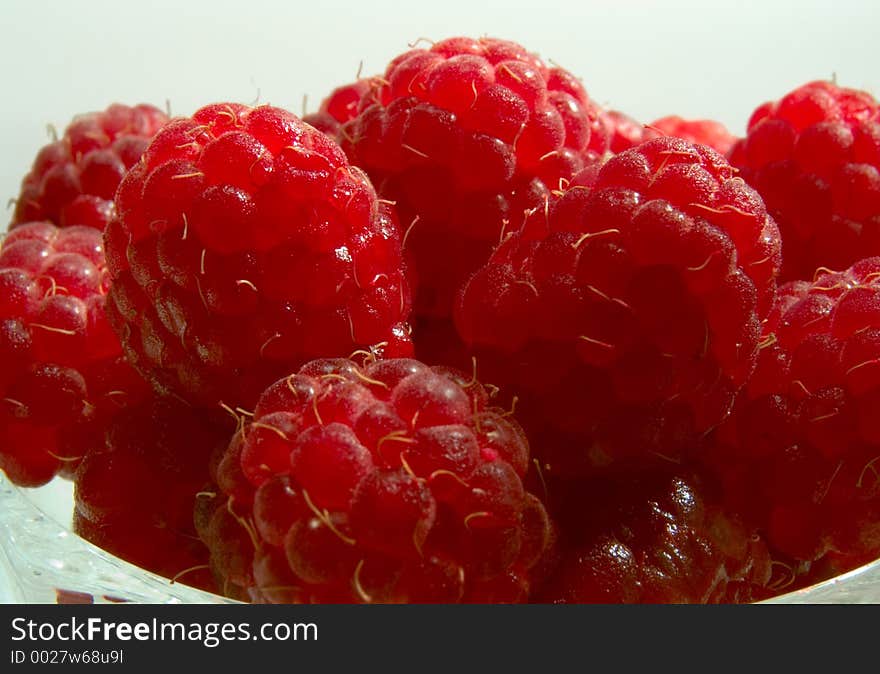 Raspberries in the glass jam dish. Raspberries in the glass jam dish