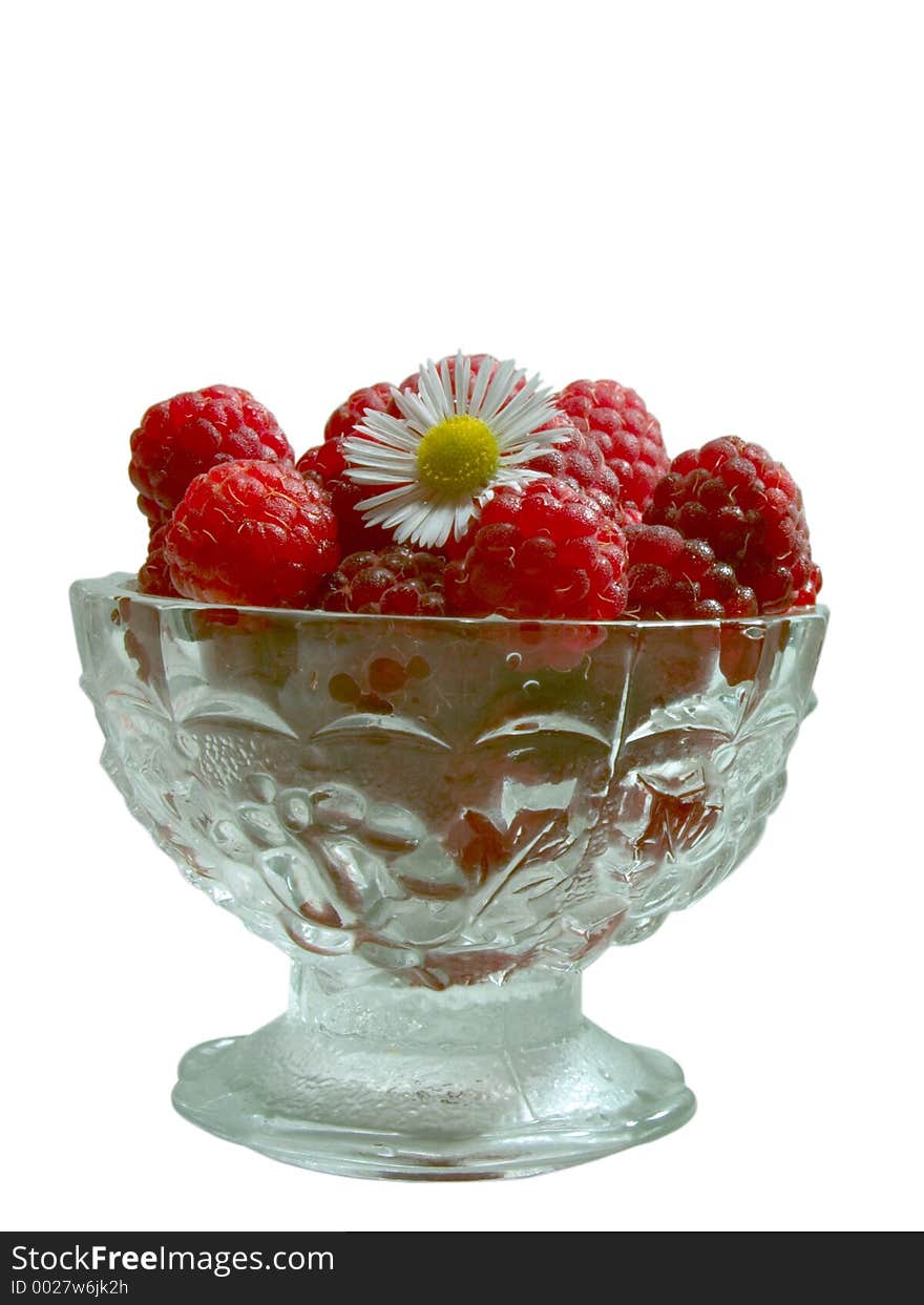 Front view of raspberries in the glass jam dish with camomile. Front view of raspberries in the glass jam dish with camomile