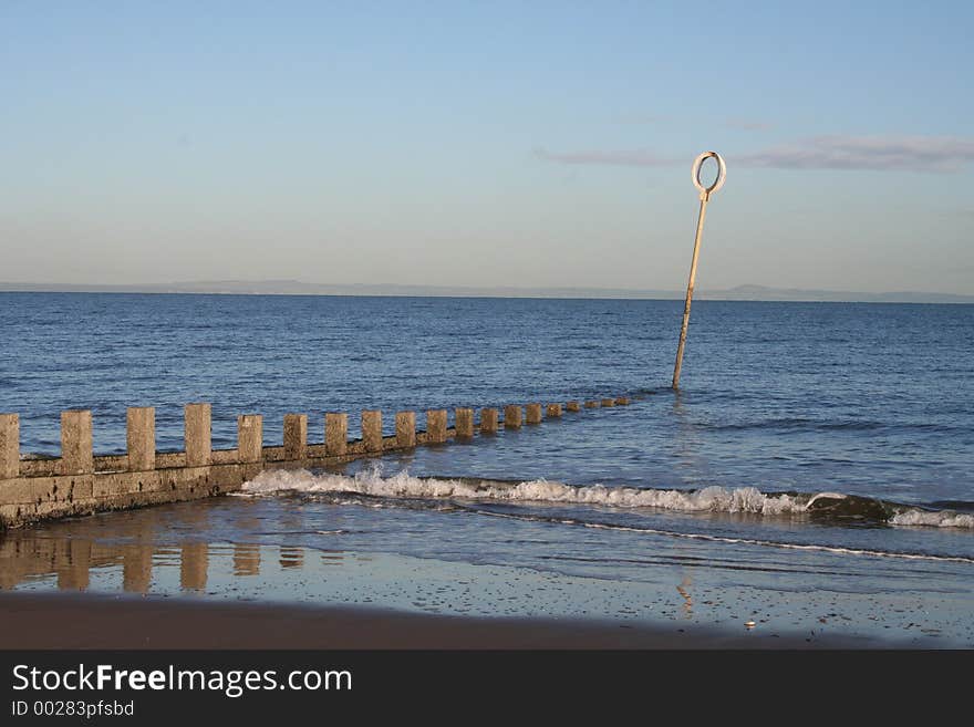 A calming image looking at sea wall out to sea.