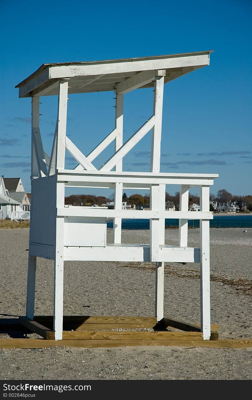 Vacant lifeguard station on a sandy shoreline beach. Vacant lifeguard station on a sandy shoreline beach.