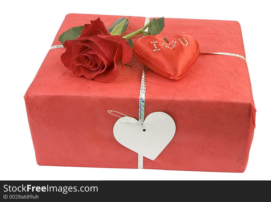 Red parcel with rose bud and cushion spelling outi l luv you,with blank label for copy. Red parcel with rose bud and cushion spelling outi l luv you,with blank label for copy