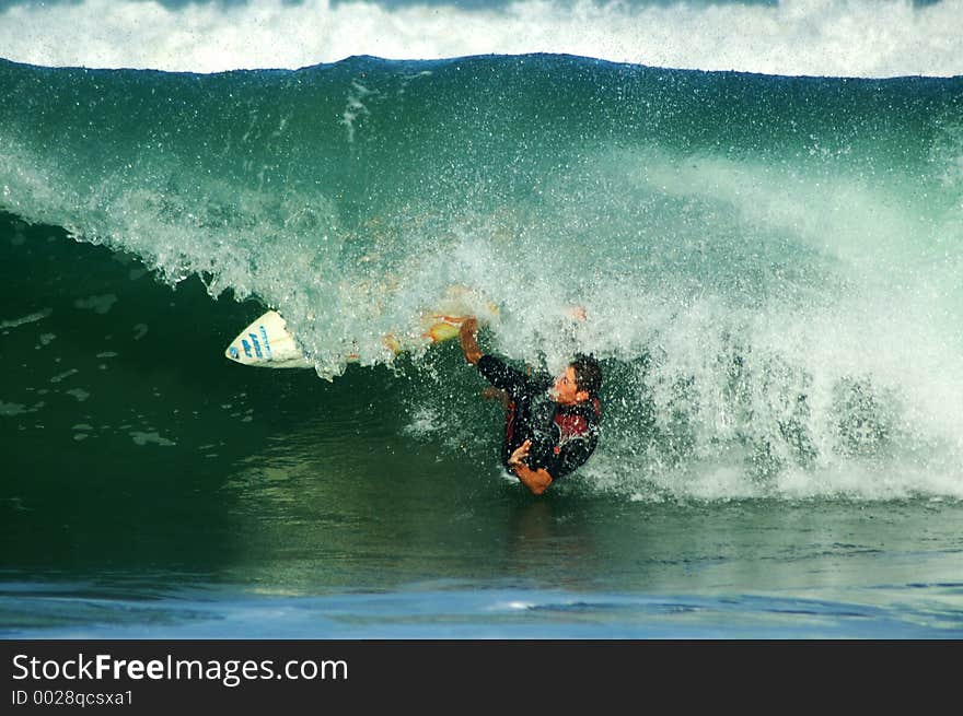 Surfer going under the wave break. Surfer going under the wave break