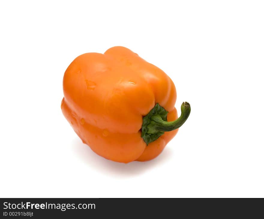 Orange bulgarian pepper over the white. Orange bulgarian pepper over the white