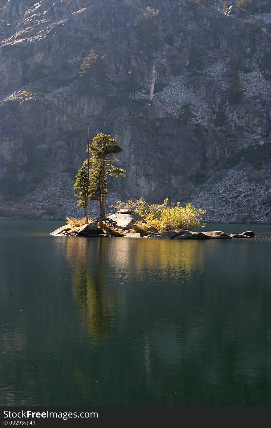 A small island in the middle of a mountain lake. A small island in the middle of a mountain lake.