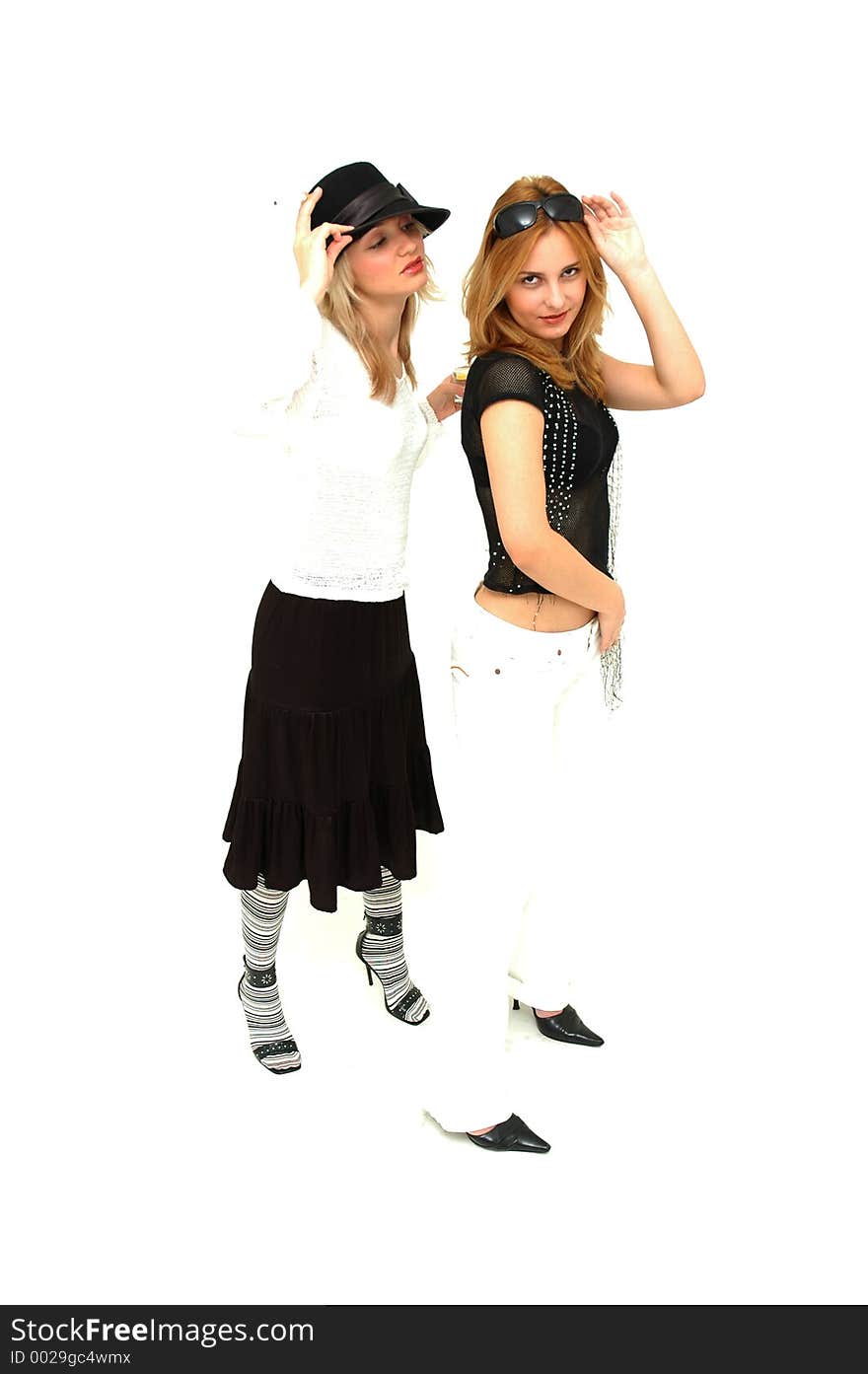 Glam girls posing on a bright white background