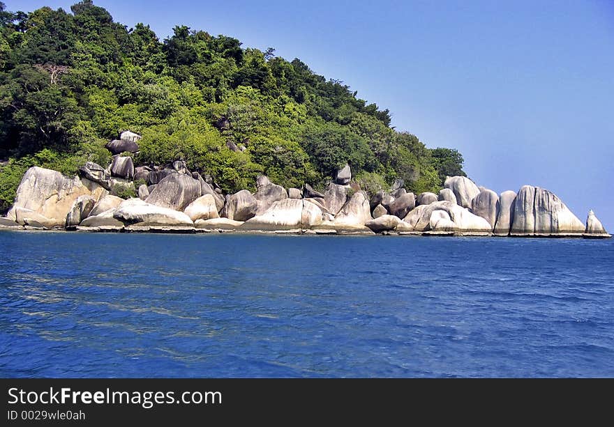 Beautiful landscape of a tropical island. You can see lines of water level due to low tide on the rocks. Beautiful landscape of a tropical island. You can see lines of water level due to low tide on the rocks