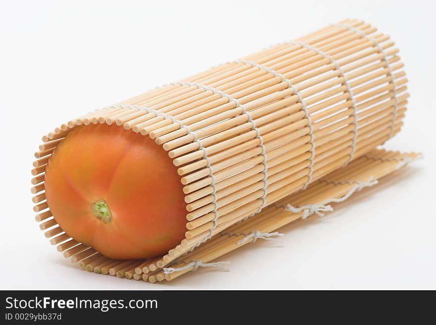 Tomato rolled in bamboo shushi makisu. Tomato rolled in bamboo shushi makisu