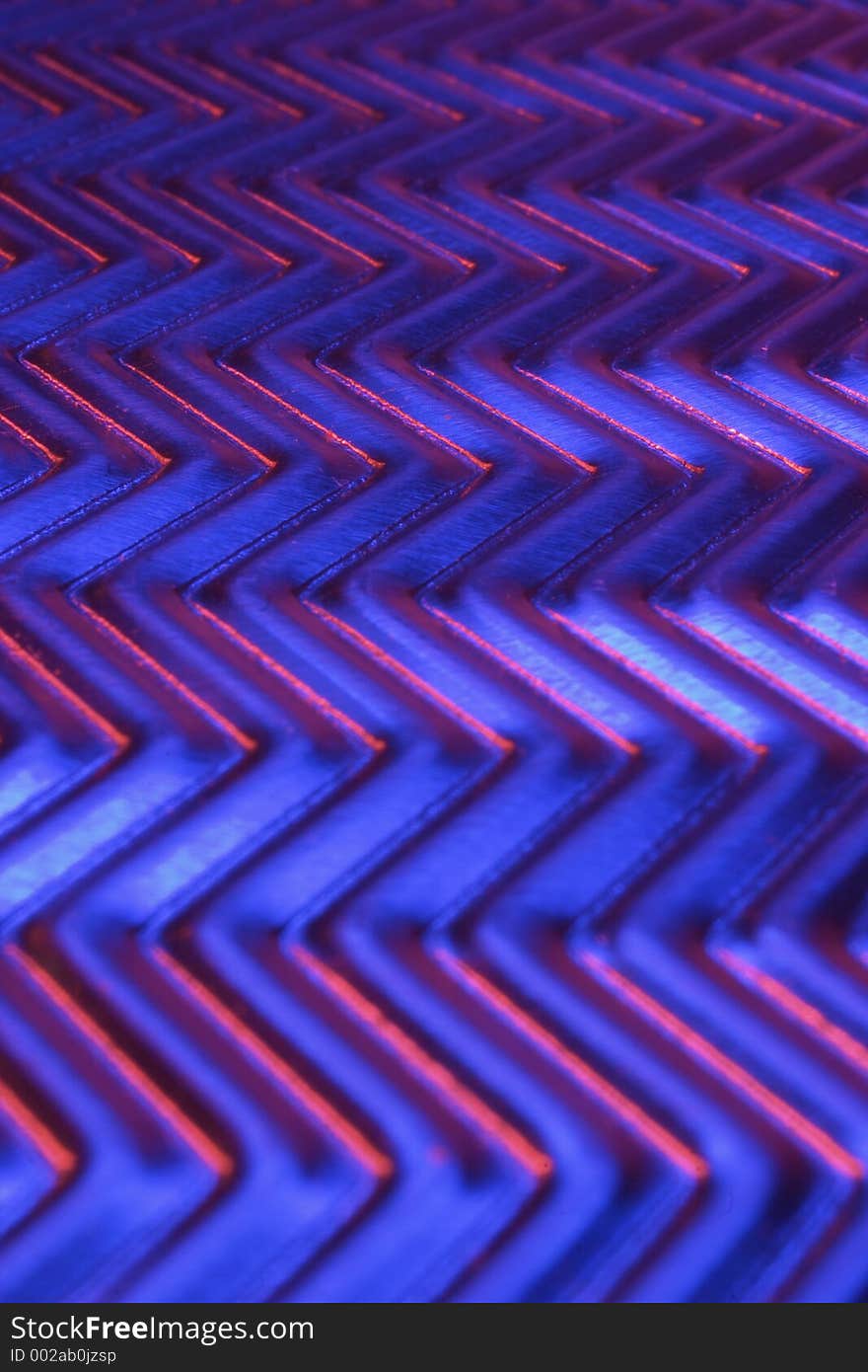 Close-up of metal plate under low light.