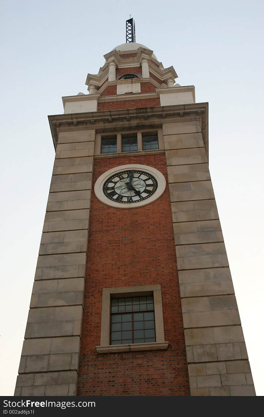 View of the clock tower in Kowloon, Hong Kong, around sunset.