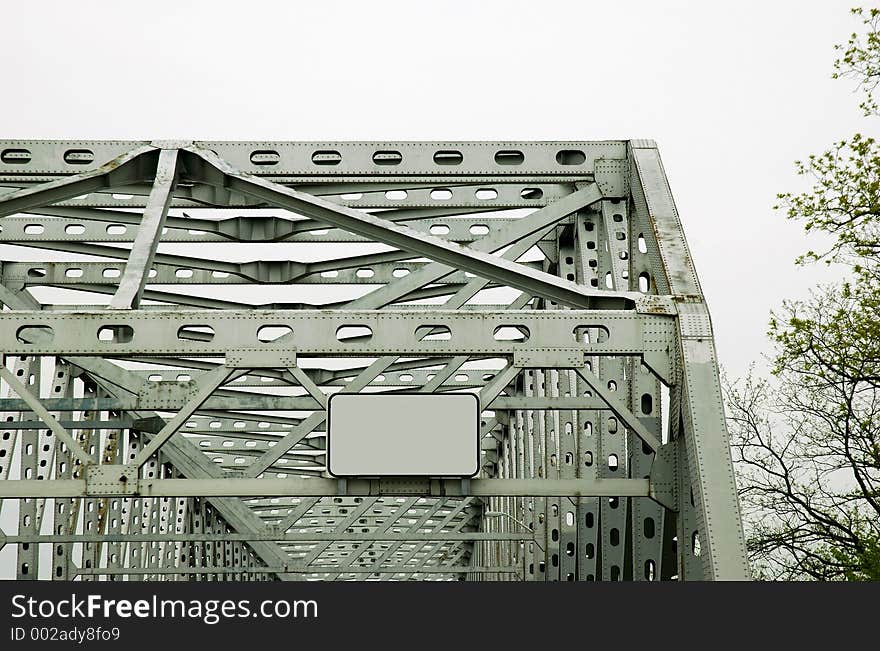 Steel bridge with blank sign.