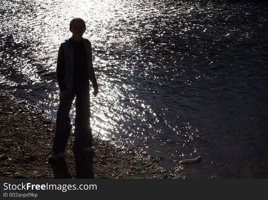 Young girl in front of water. Young girl in front of water