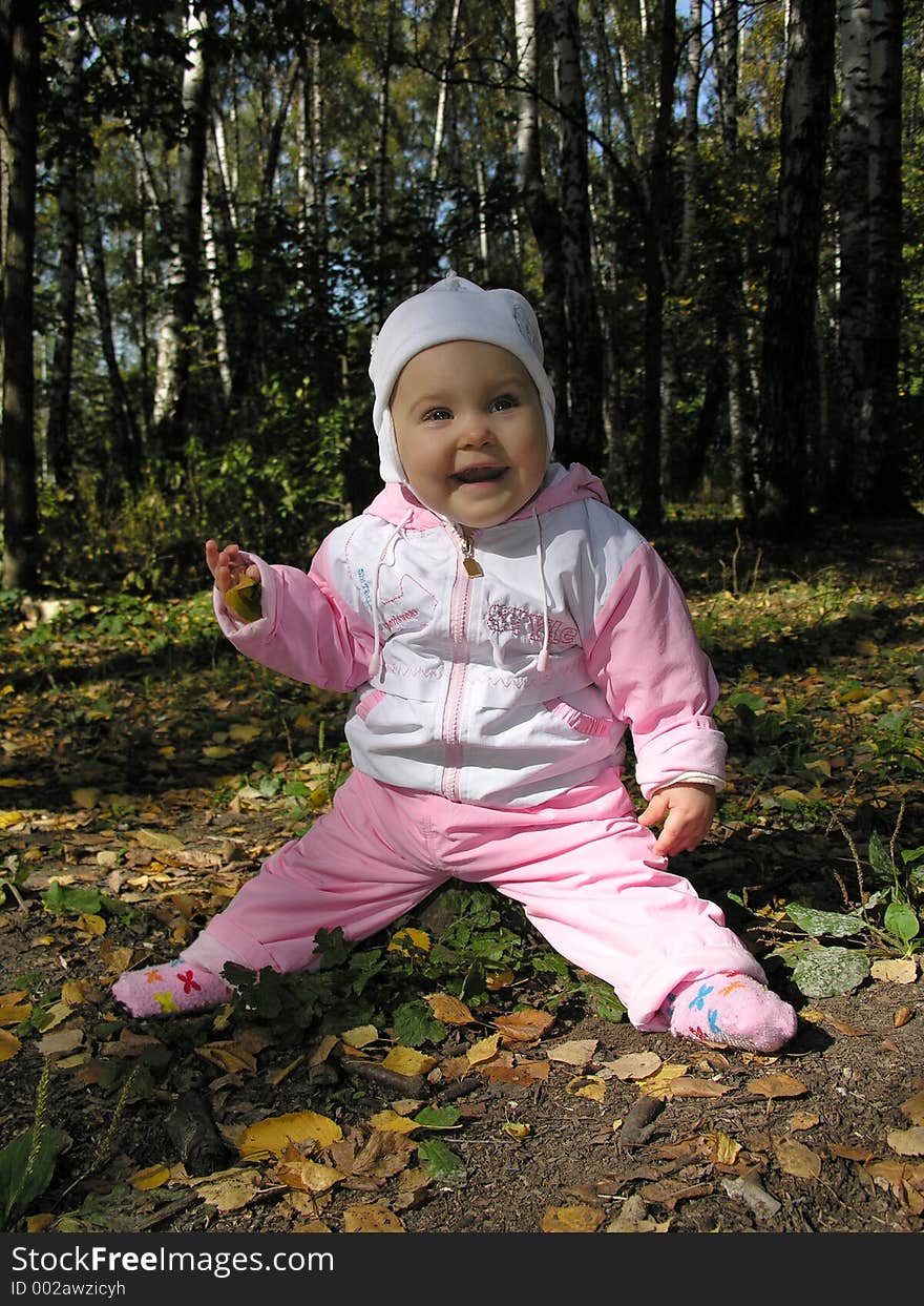 Baby on stump in autumn wood