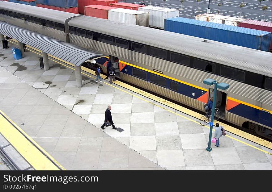 Morning commuters get on board at the train station. Morning commuters get on board at the train station.