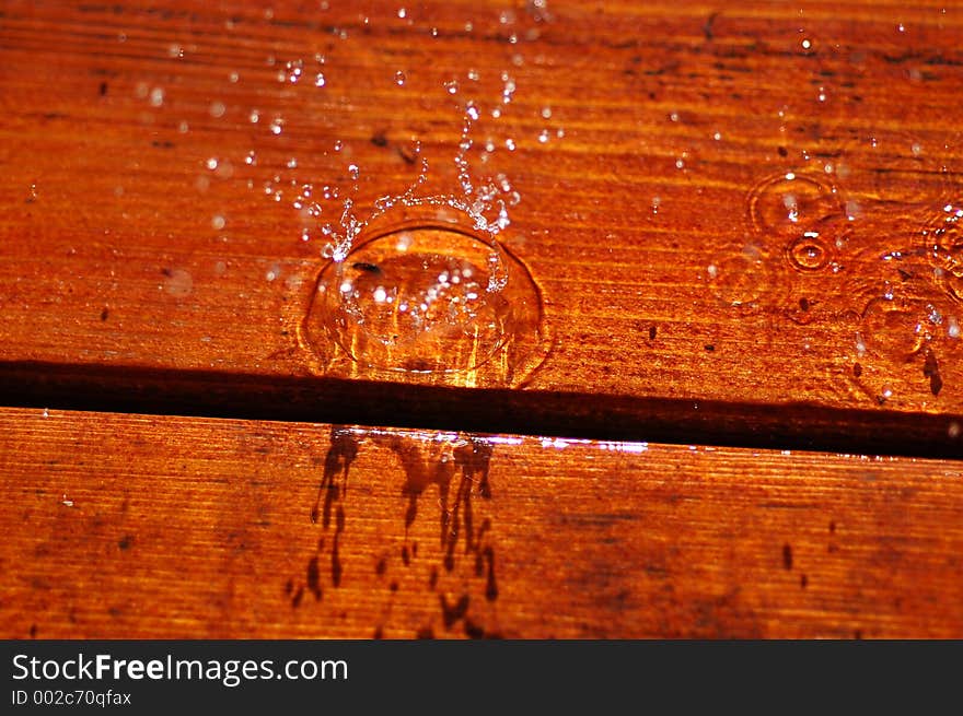 Water drops falling on wooden surface. Water drops falling on wooden surface.