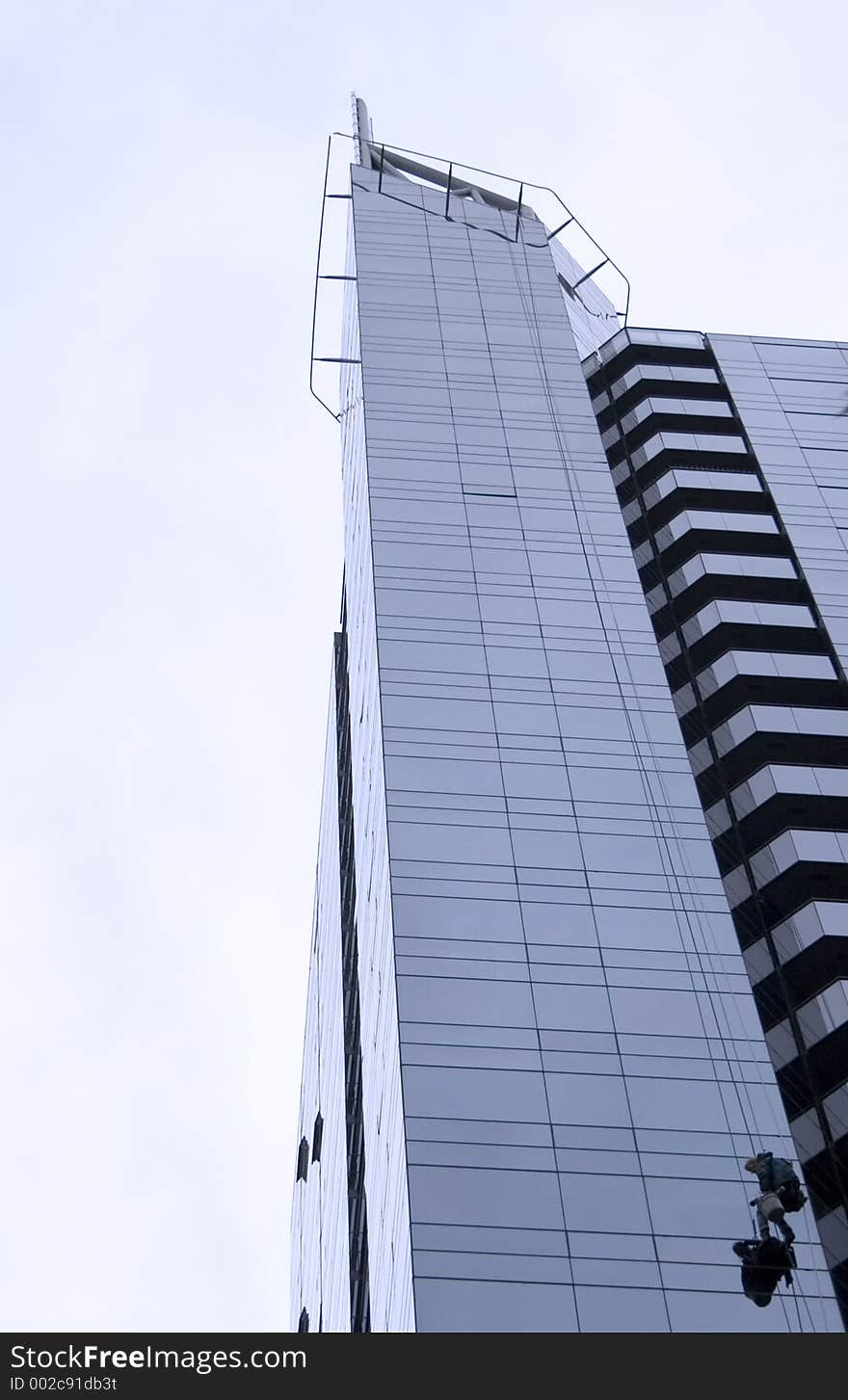 Window washer scaling skyscraper