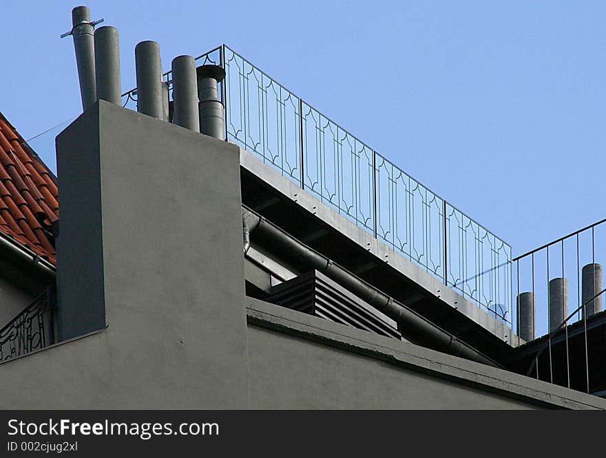 Details of architectural details of a modern villa, with a blue sky in the back.