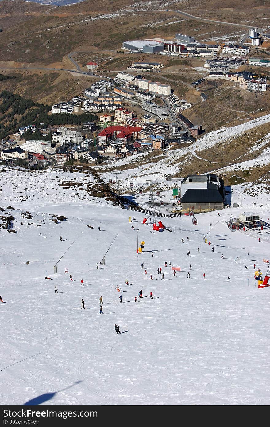 Looking down the busy ski slopes of the Sierra Nevada mountains in Spain to the resort town of Pradollano. Looking down the busy ski slopes of the Sierra Nevada mountains in Spain to the resort town of Pradollano