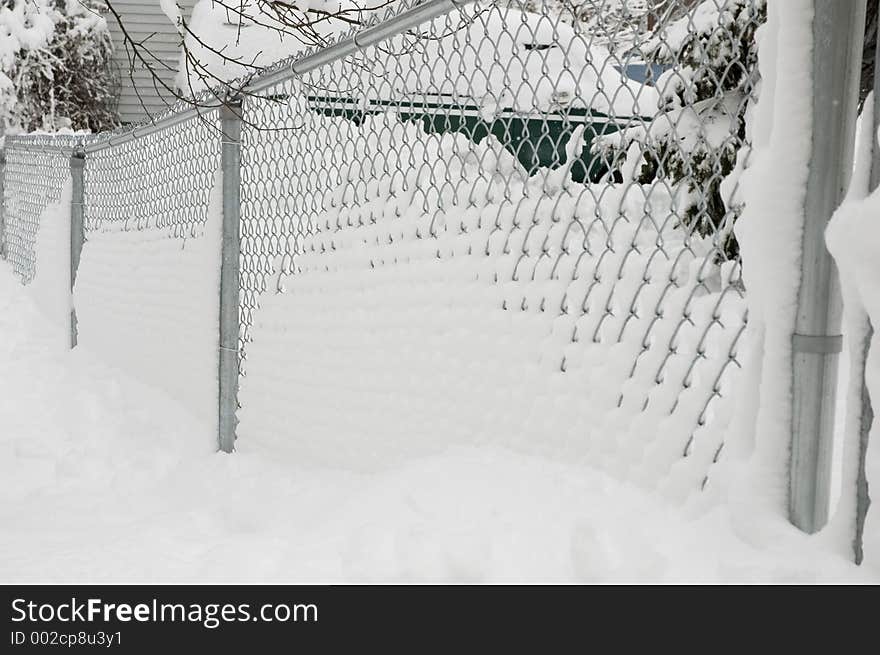 A Snow covered chain link fence. A Snow covered chain link fence