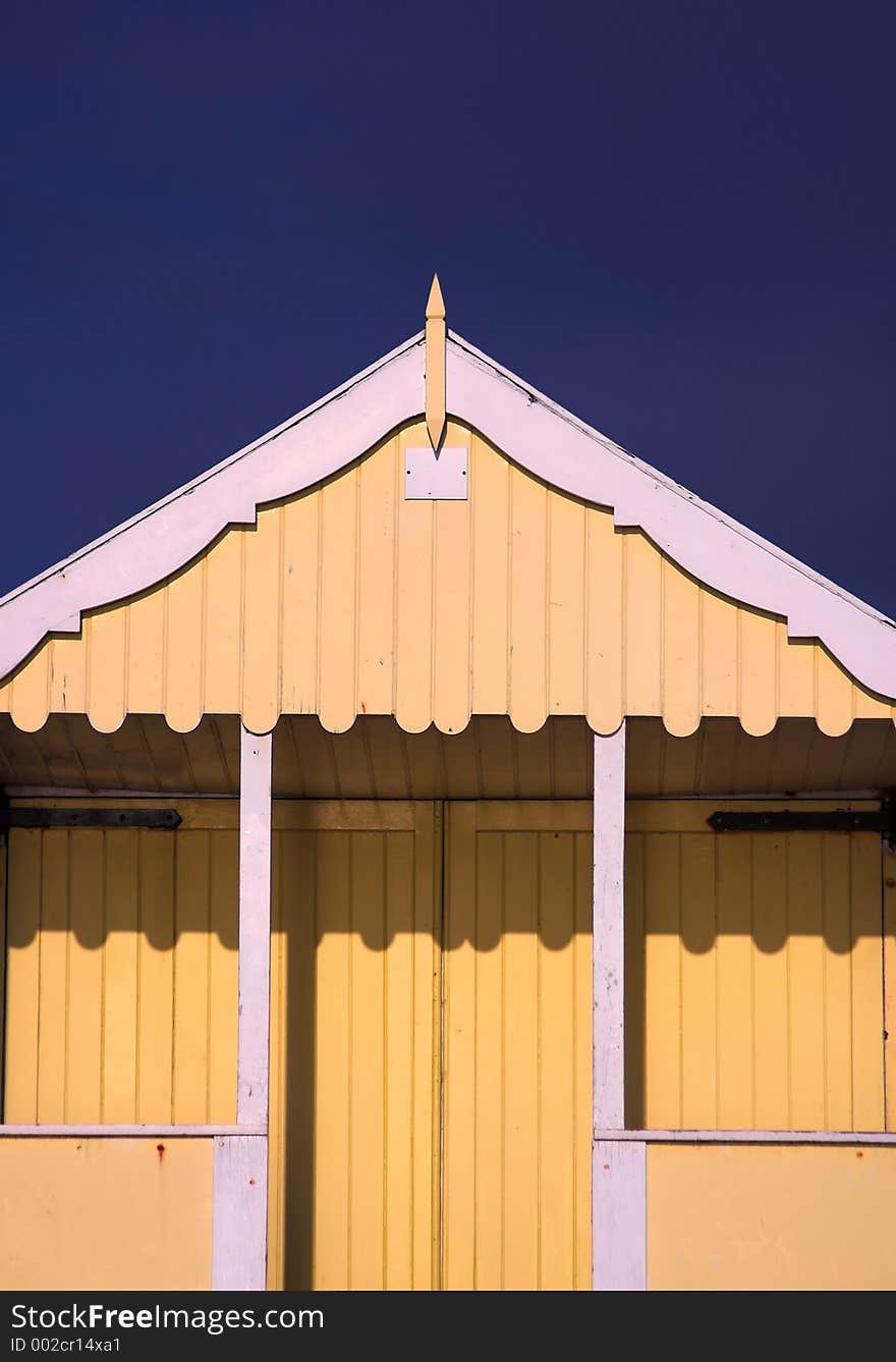 Yellow wooden beach hut, England