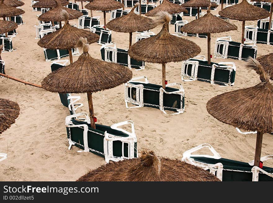 Sun umbrellas on an empty beach. Sun umbrellas on an empty beach