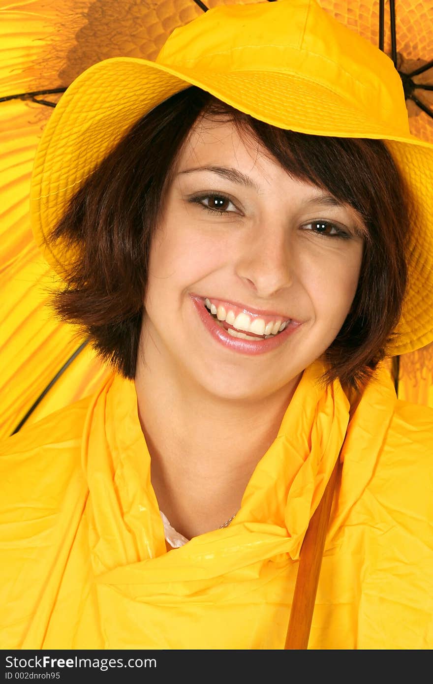 Girl smiles in her bright yellow rain gear and umbrella. Girl smiles in her bright yellow rain gear and umbrella