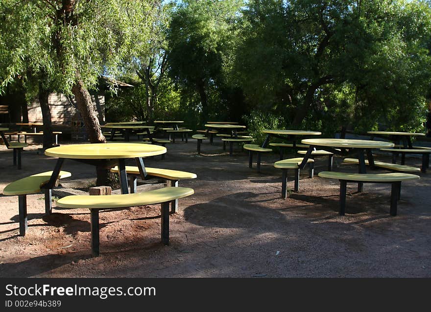 Abandoned picnic area with yellow tables. Abandoned picnic area with yellow tables