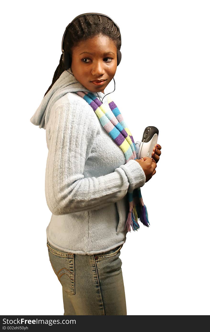 A pretty teenage girl listening to a portable cd player. With clipping path. A pretty teenage girl listening to a portable cd player. With clipping path.