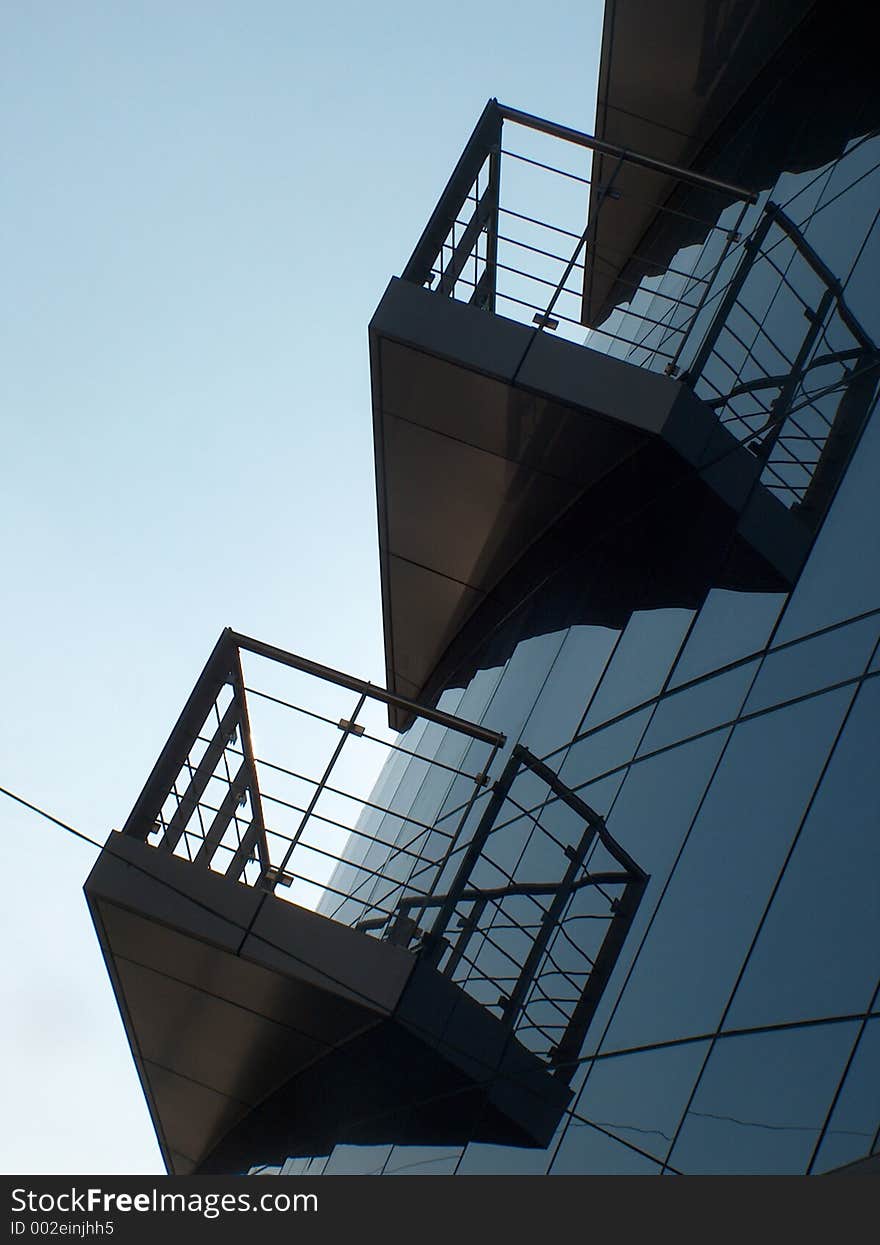 Modern building with terraces - blue tones. Copy space in the sky. Modern building with terraces - blue tones. Copy space in the sky.