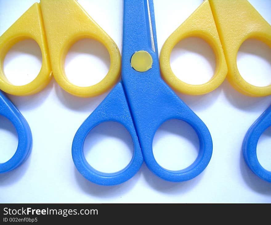 Closeup of blue and yellow scissors. Closeup of blue and yellow scissors