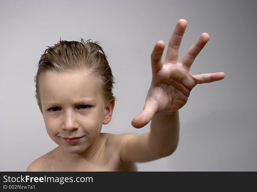 Kid posing with serious look. Focus on face.