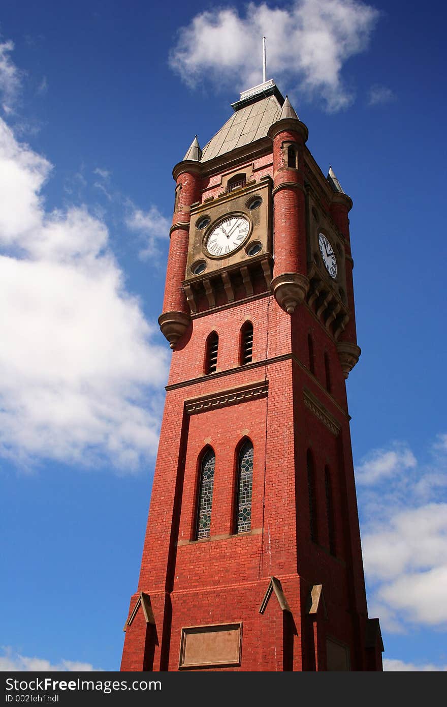 Old bright clock tower against blue sky. Old bright clock tower against blue sky