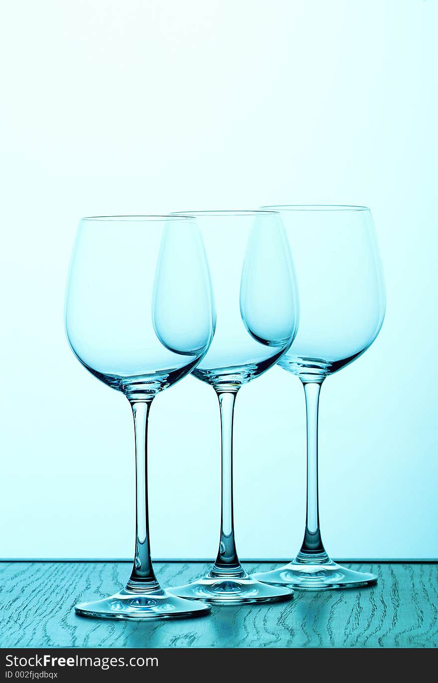 Three wine glasses in blue backlight. Three wine glasses in blue backlight