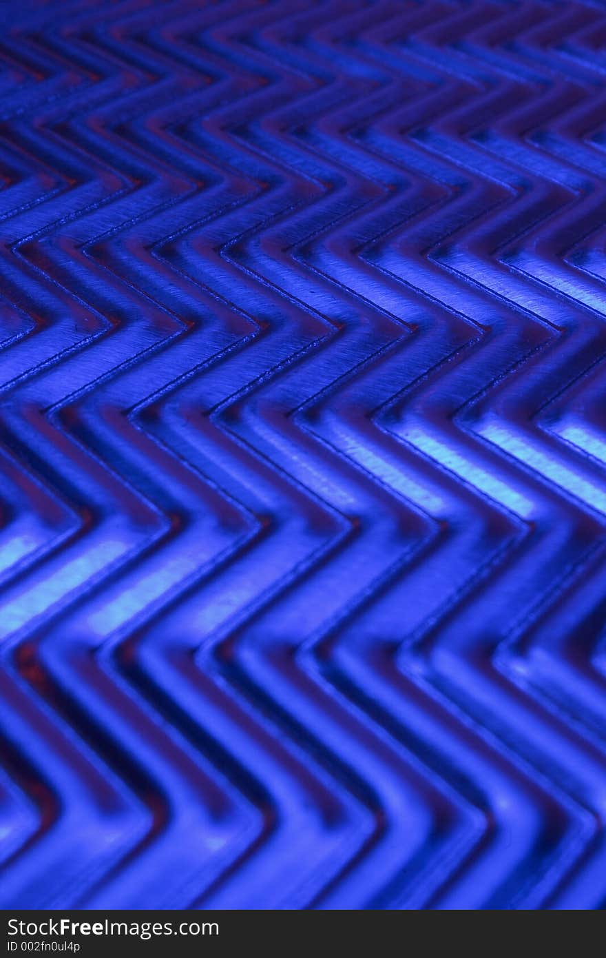 Close-up of metal plate under low light.