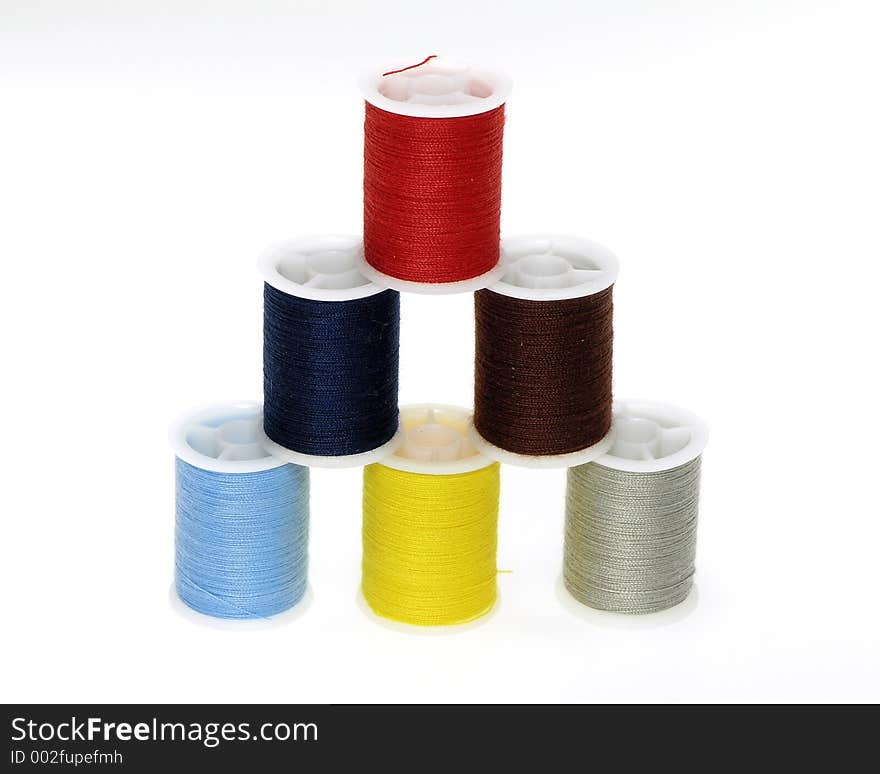 Multi colored pyramid of thread spools. Multi colored pyramid of thread spools