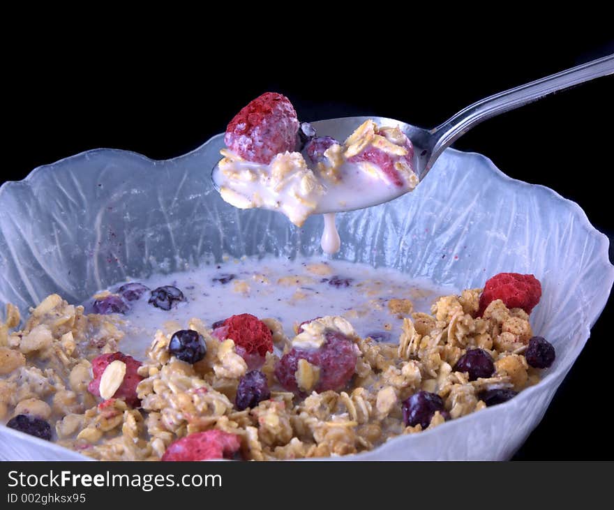 Bowl of cereal with milk dripping off spoon