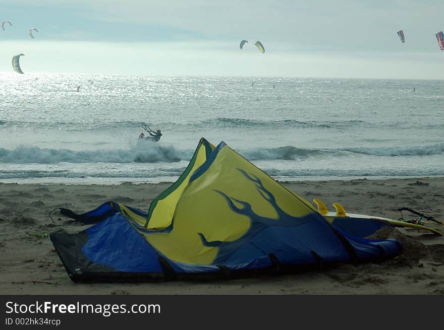 Sail from a parasurfer sits on the beach. Sail from a parasurfer sits on the beach