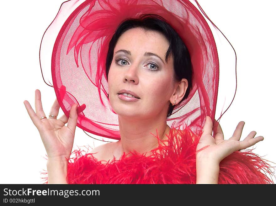 Portrait of a beautiful young woman wearing a red hat and feathered red boa over naked shoulders. Portrait of a beautiful young woman wearing a red hat and feathered red boa over naked shoulders