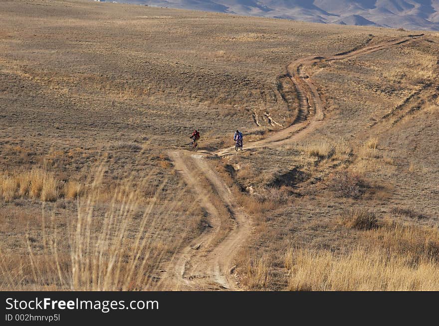 Bikers in desert road, in autumn