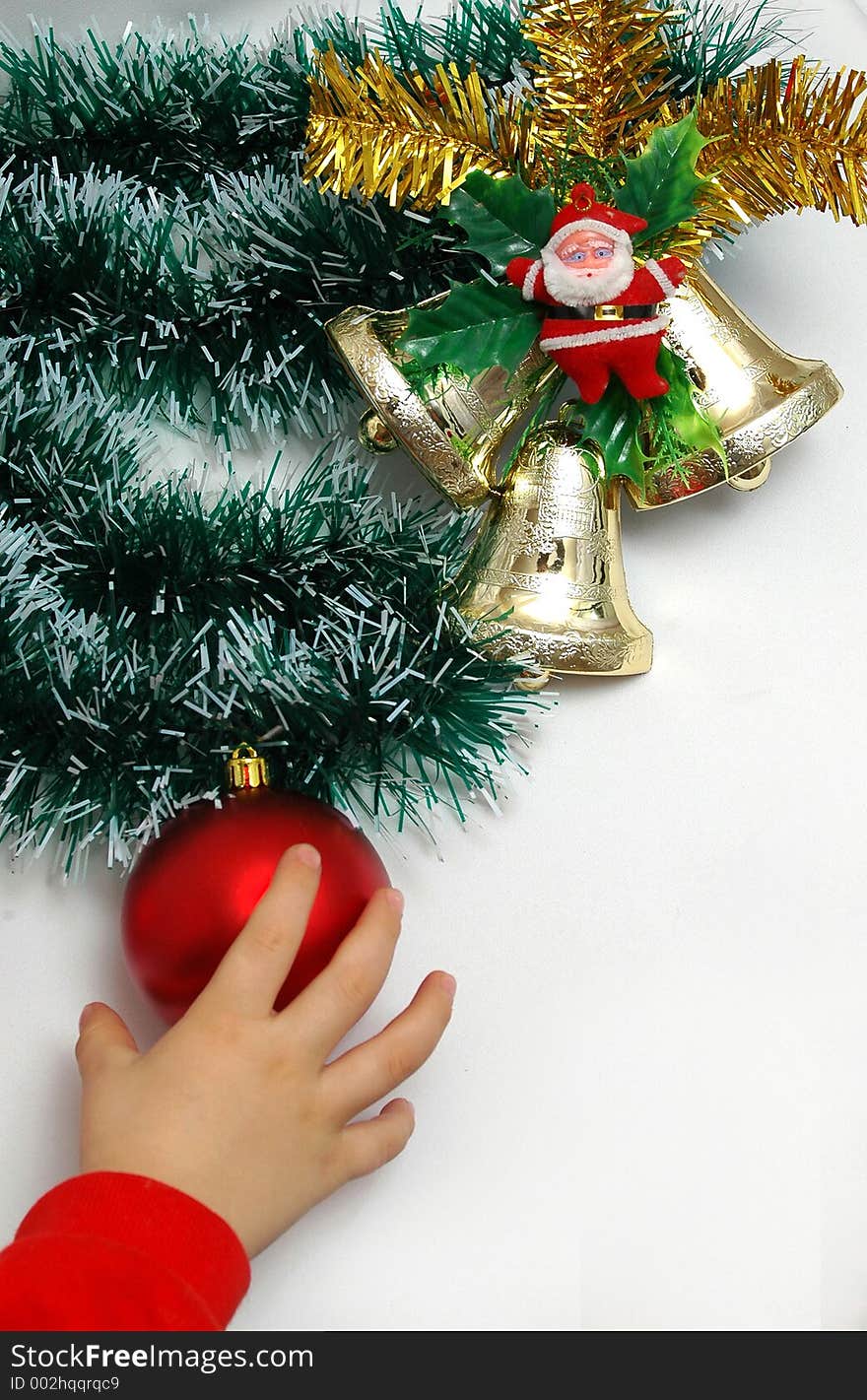 Handbells a red sphere and a bow Christmas decoration on white background